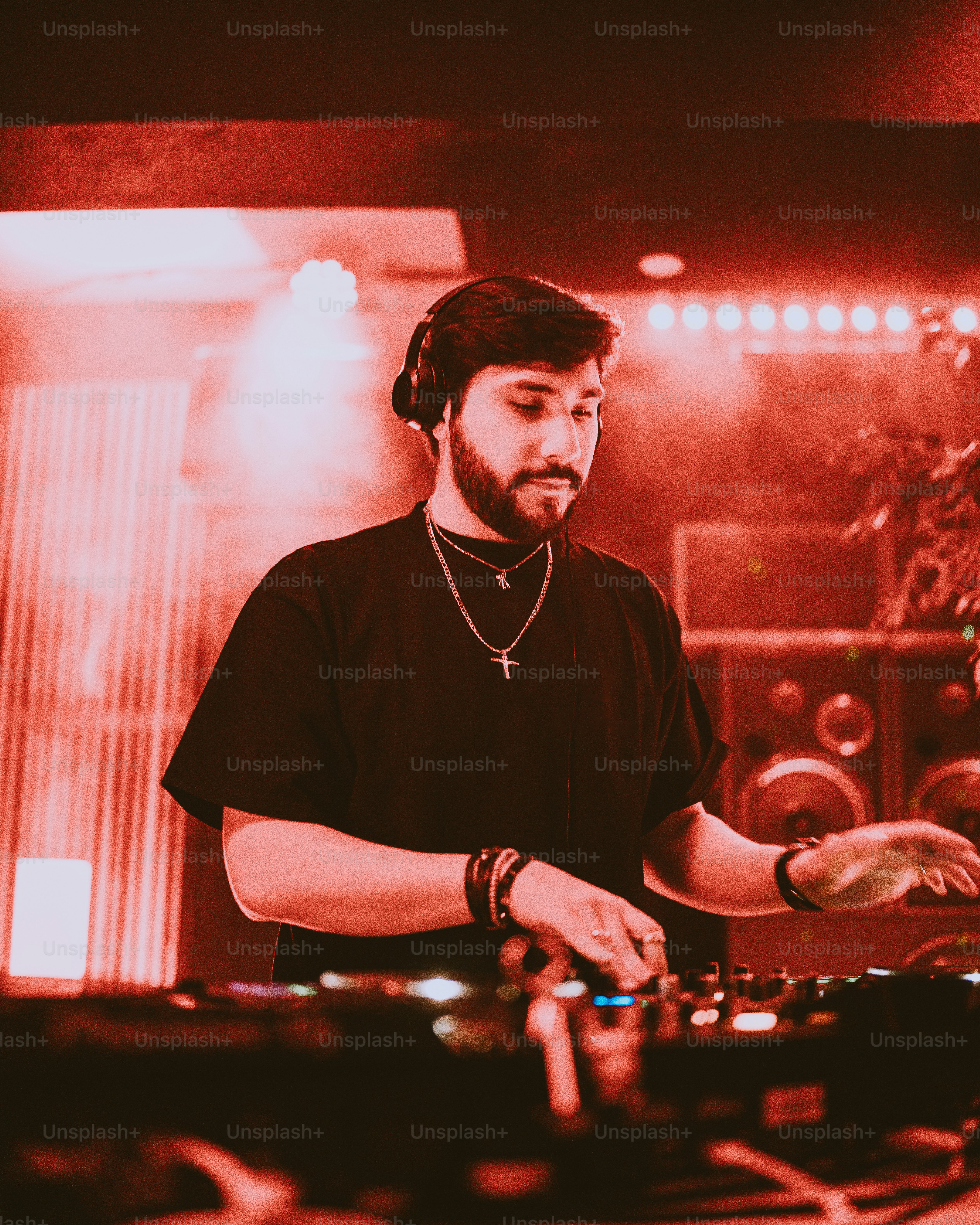 a-man-standing-in-front-of-a-mixing-desk-photo-dj-image-on-unsplash