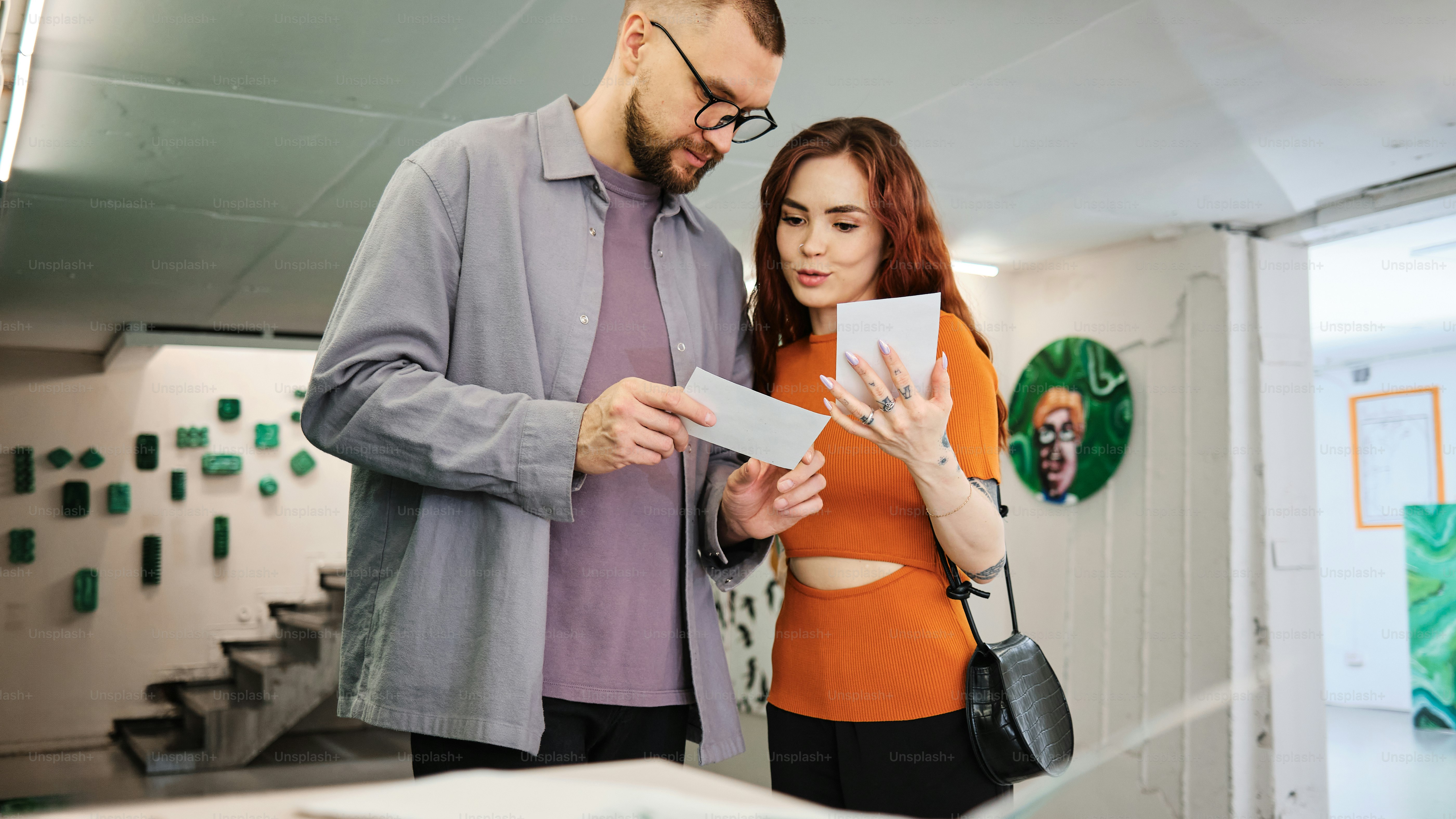 a man and a woman looking at a piece of paper