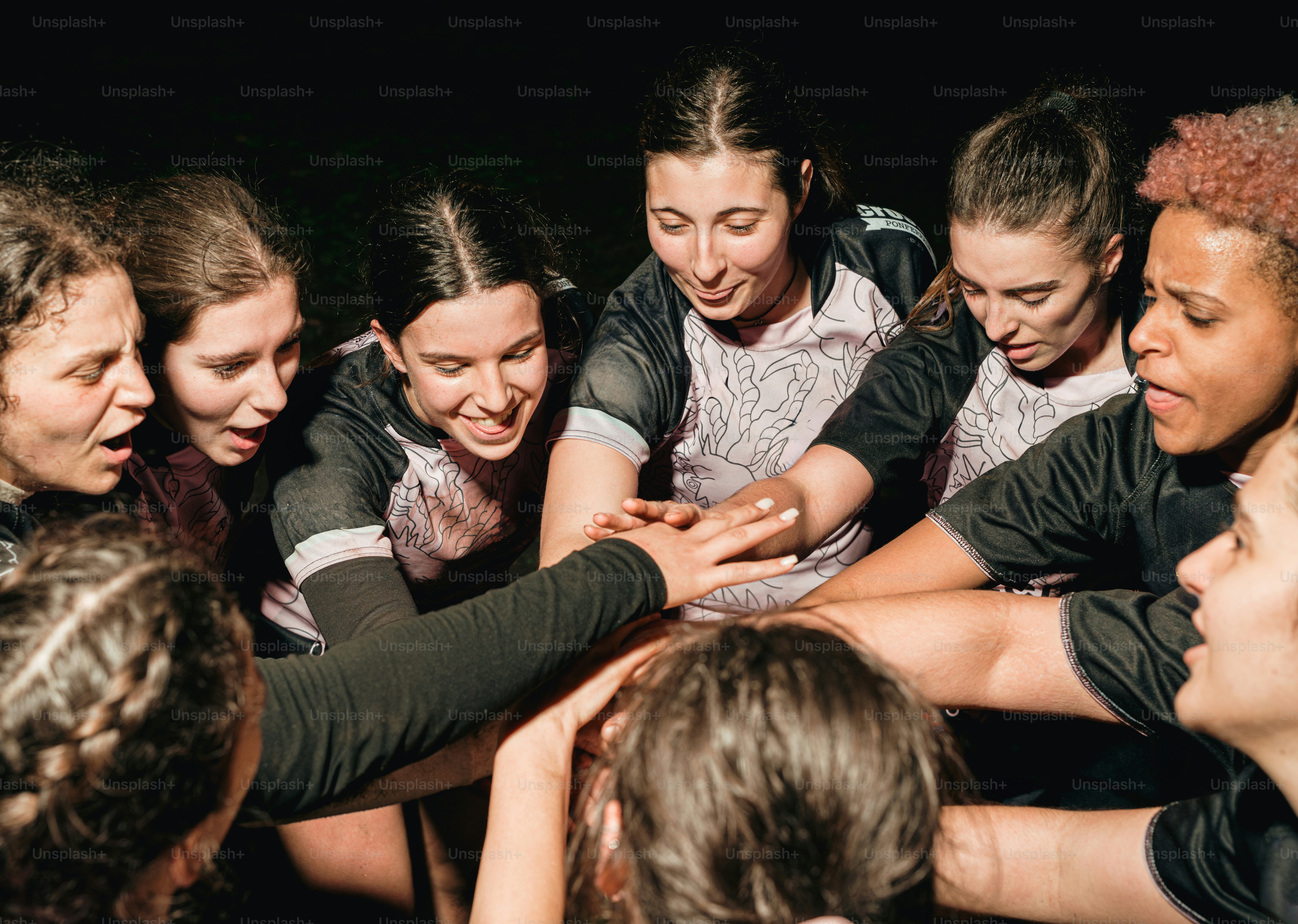 a group of young women standing around each other