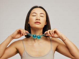 a woman holding a pair of scissors to her neck