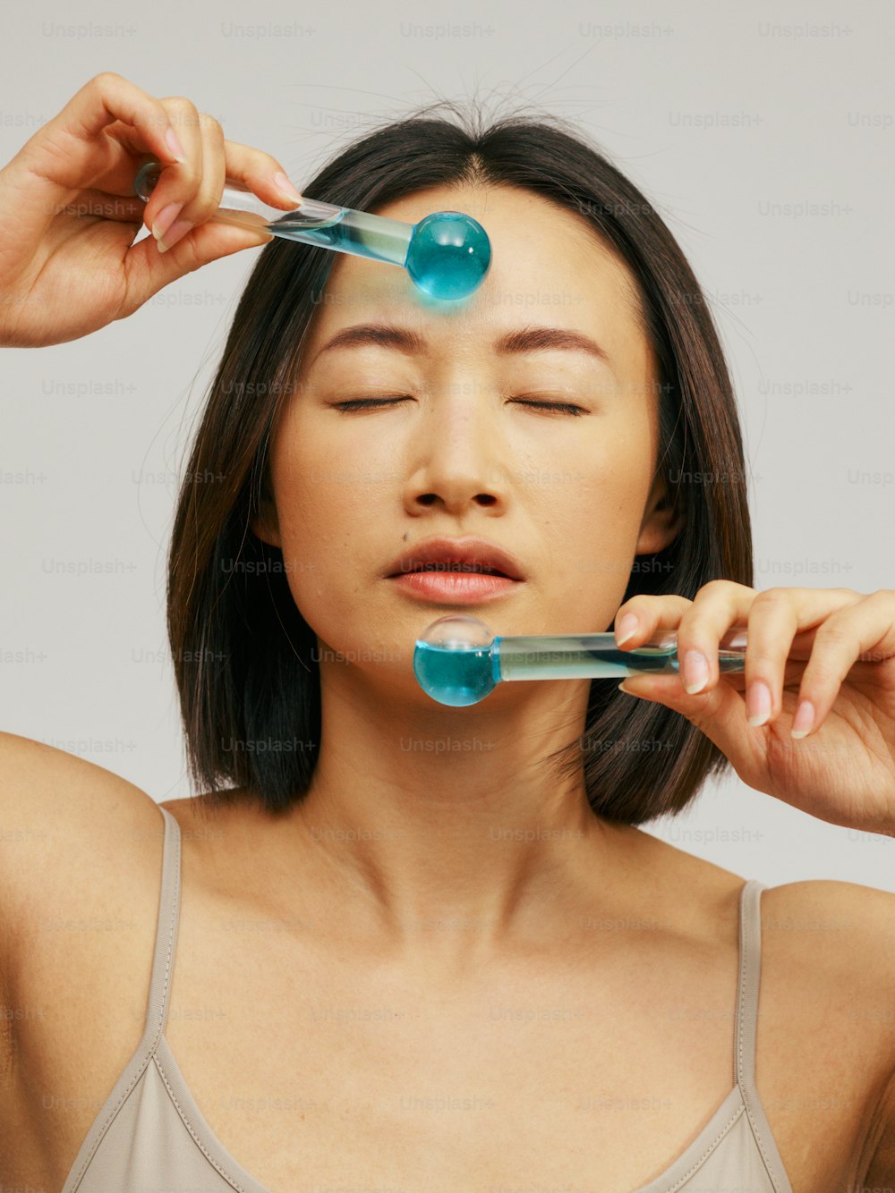 a woman holding two toothbrushes to her face