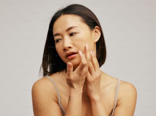 a woman holding her hands to her face