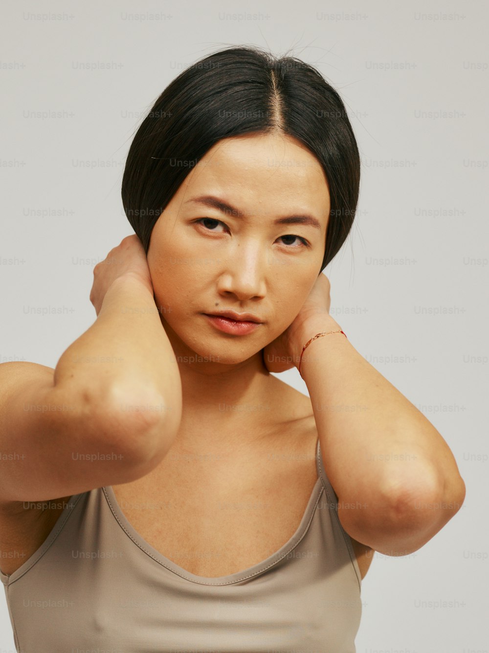 a woman is posing for a picture with her hand on her head