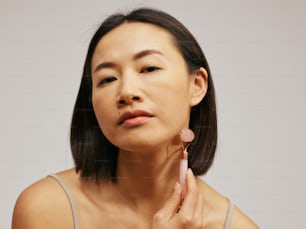 a woman is holding her ear up to her ear