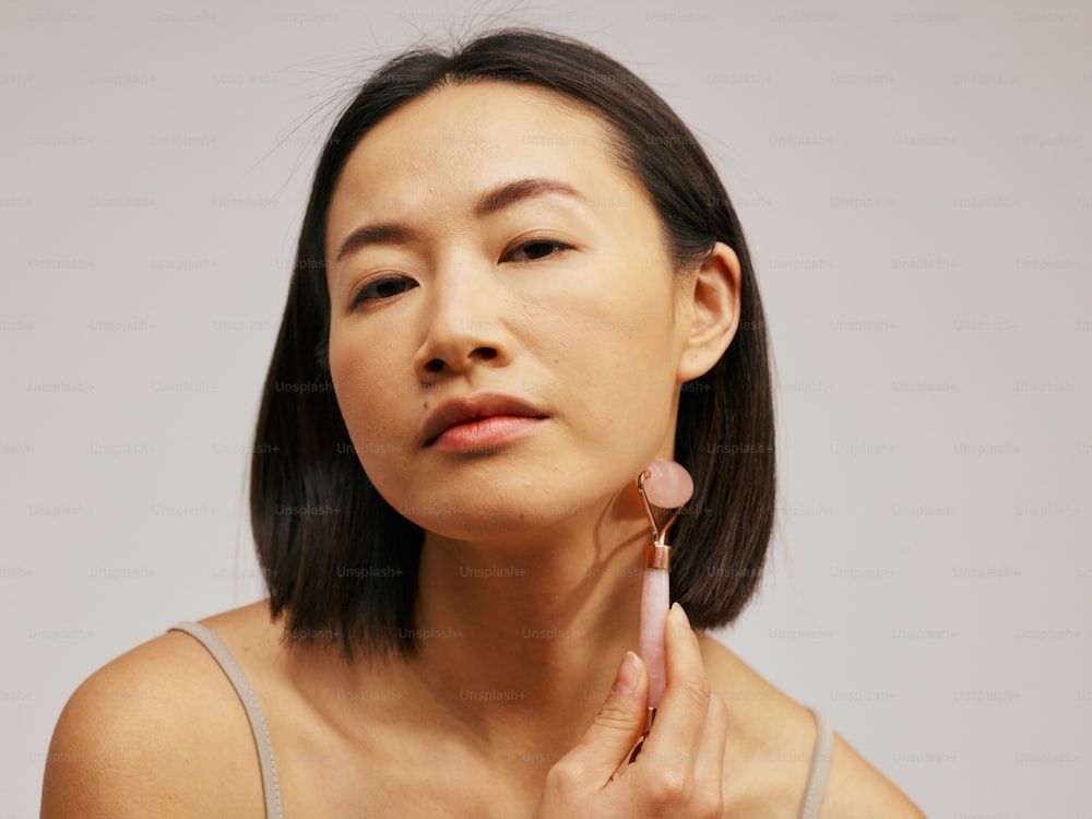a woman is holding her ear up to her ear