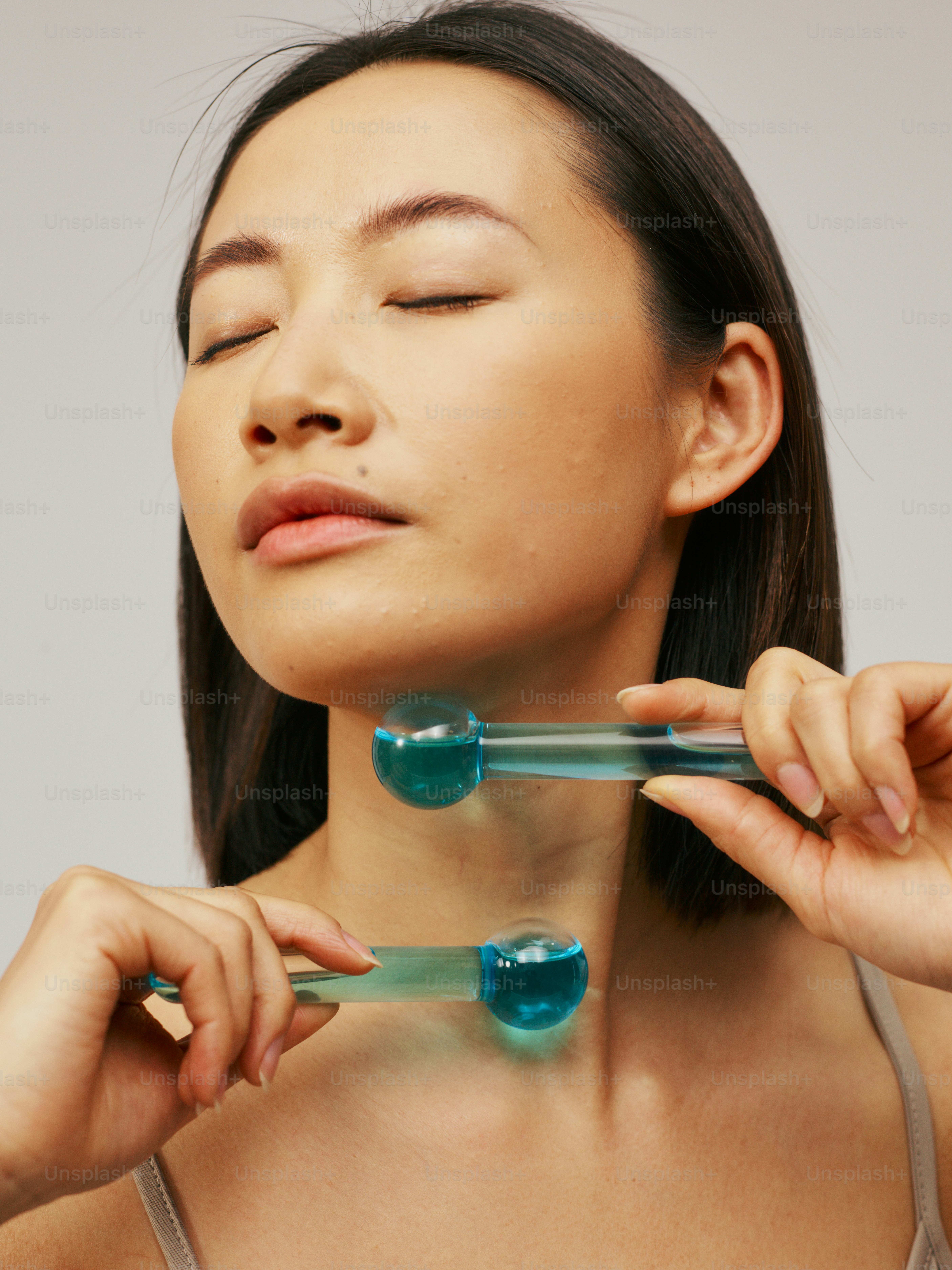 a woman holding a toothbrush in her right hand