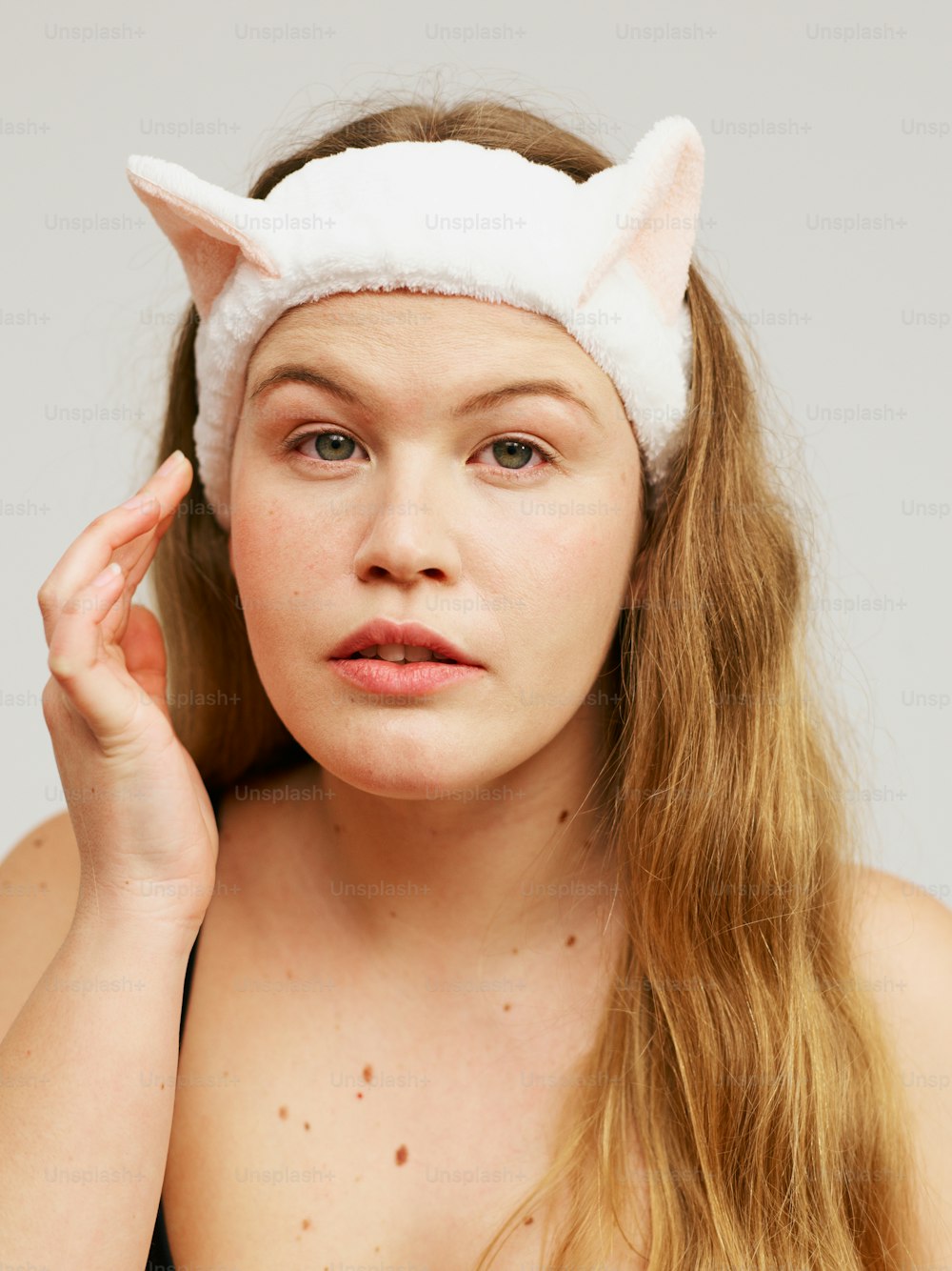 a woman with long hair wearing a cat ears headband