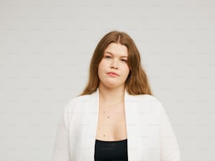 a woman in a black top and a white cardigan