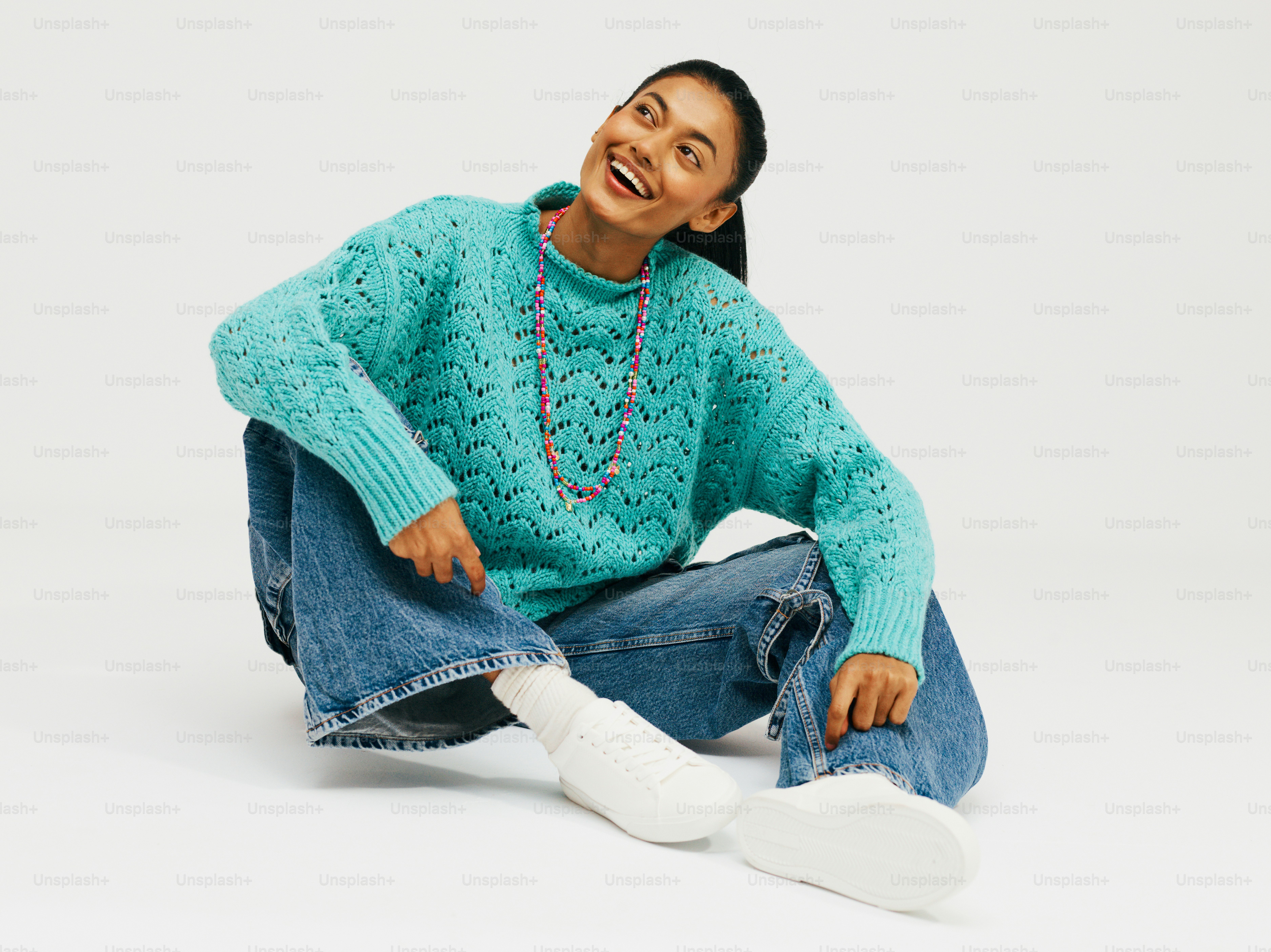 a woman sitting on the ground laughing