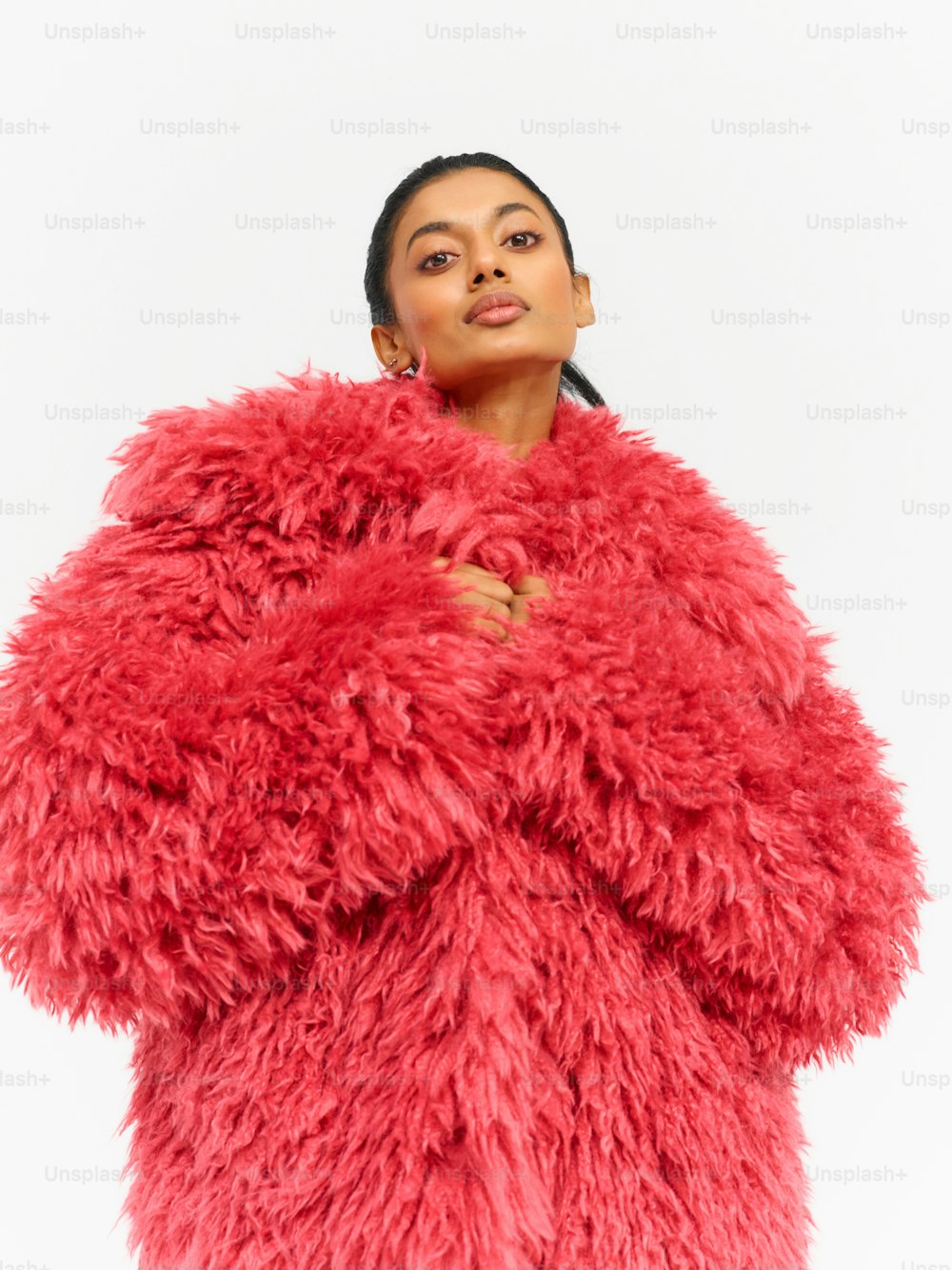 a woman in a red furry coat