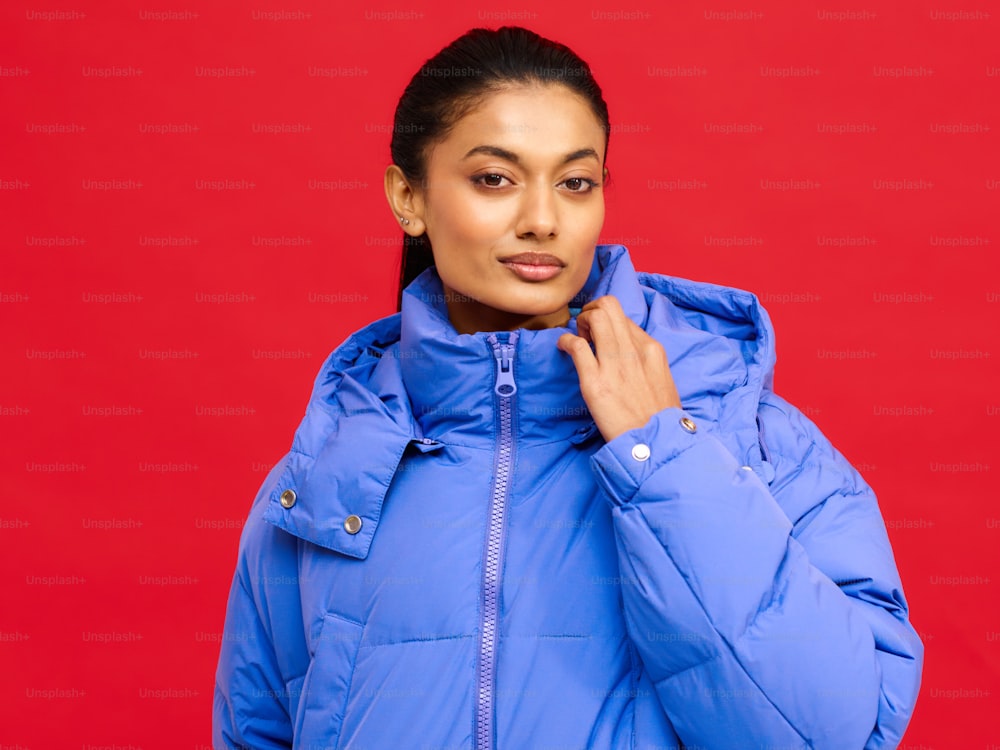 a woman in a blue jacket posing for a picture