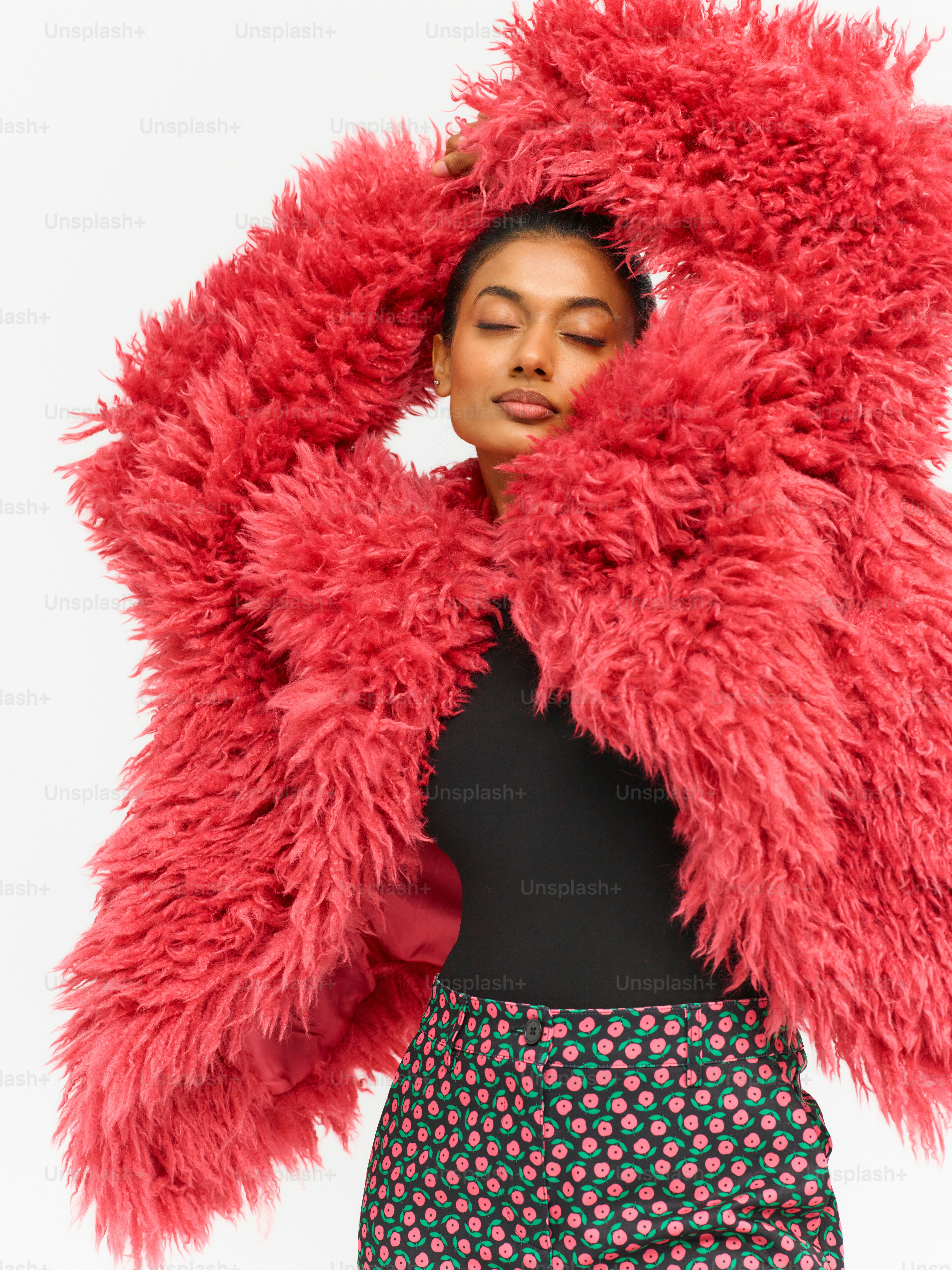 a woman in a black top and a red jacket