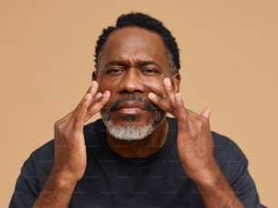 a man with his hands on his face