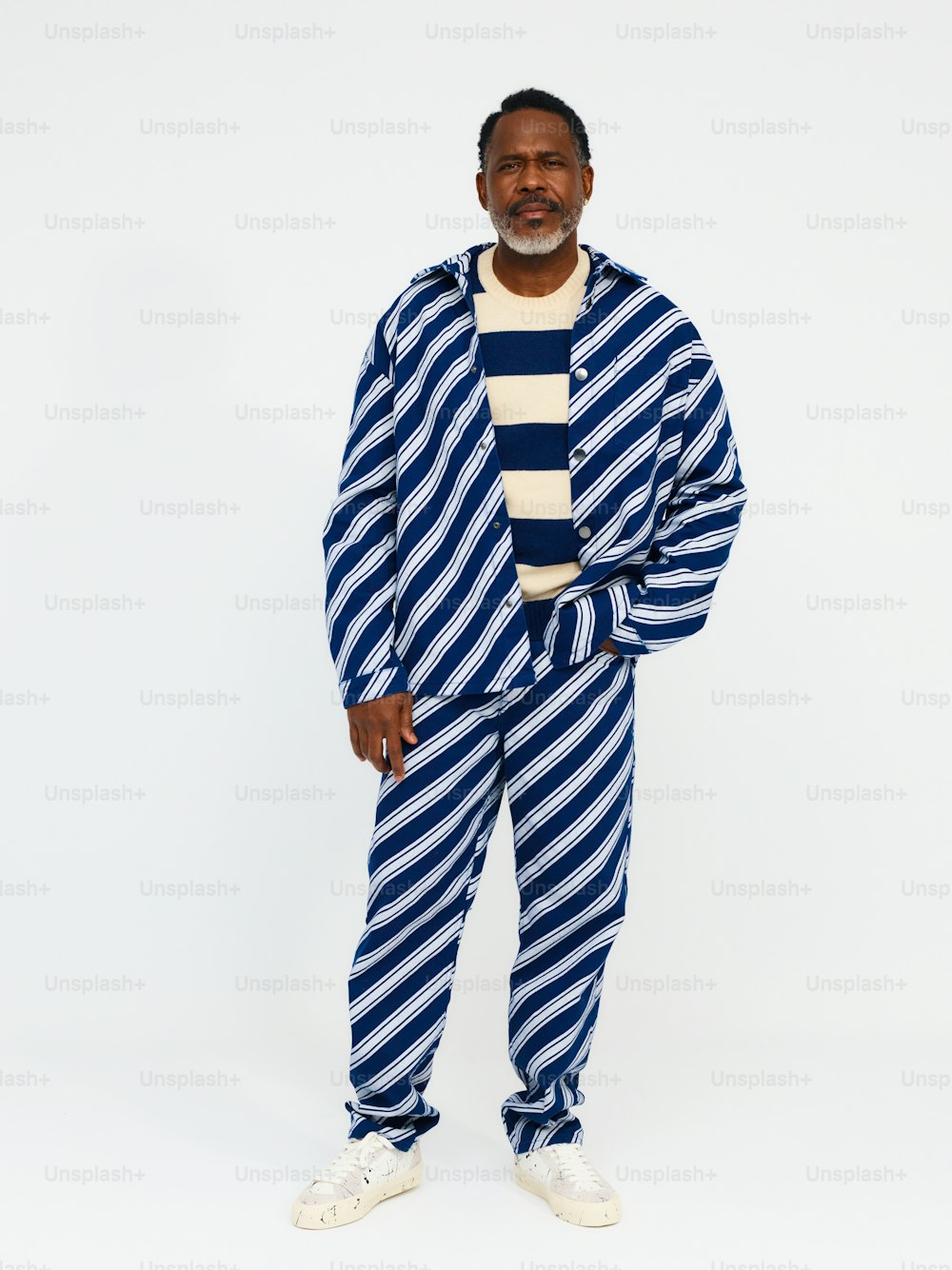 un uomo in un abito a righe bianche e blu