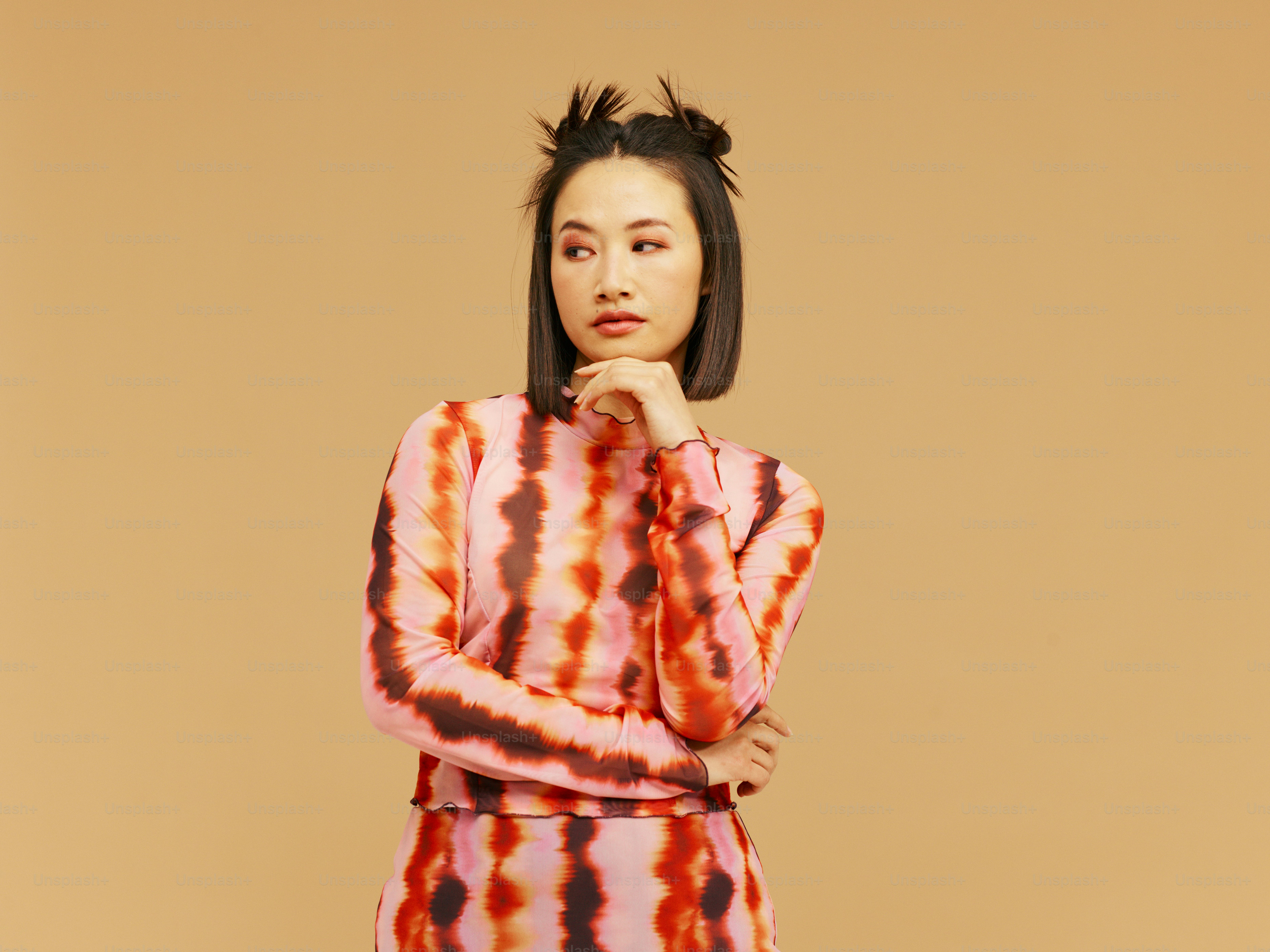 a woman in a tie dye dress poses for a picture