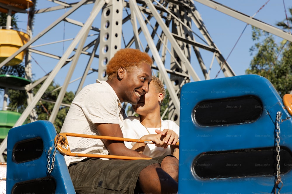 a man and a woman sitting on a roller coaster