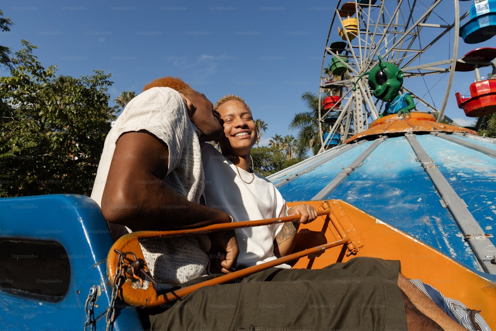 a man and a woman riding on a roller coaster
