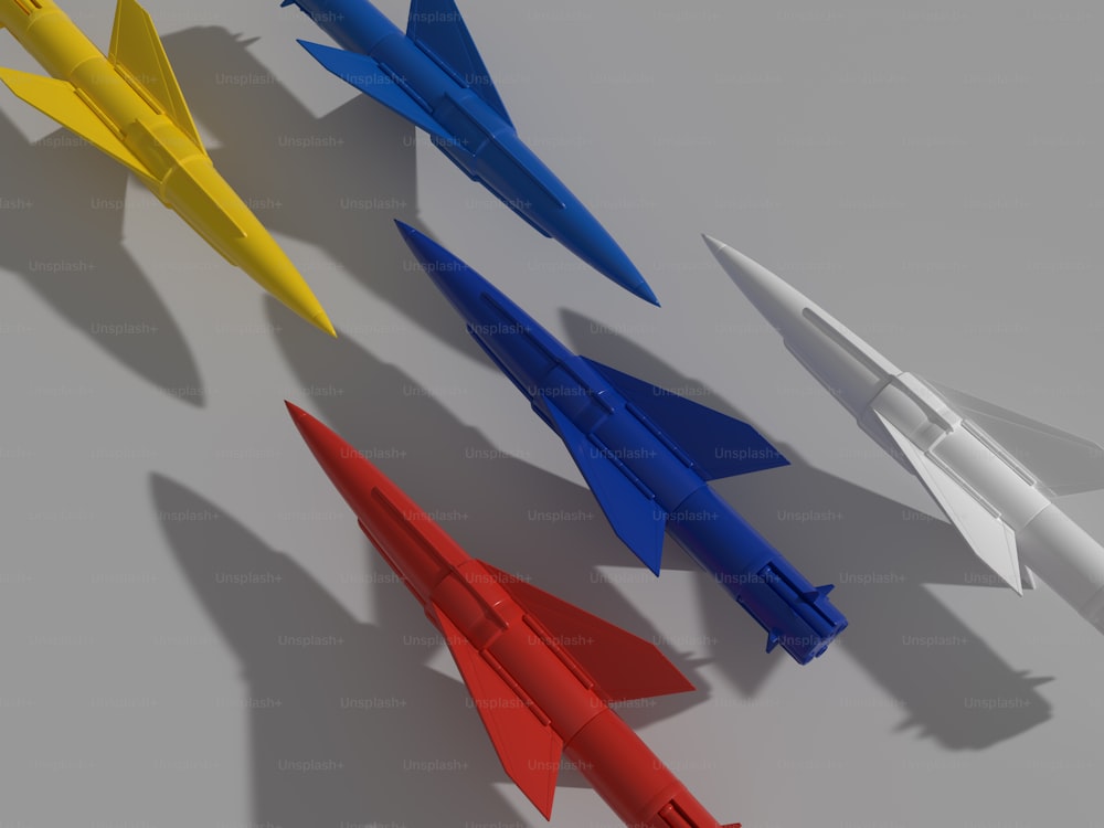 a group of four different colored rockets sitting next to each other