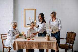 a group of women standing around a table