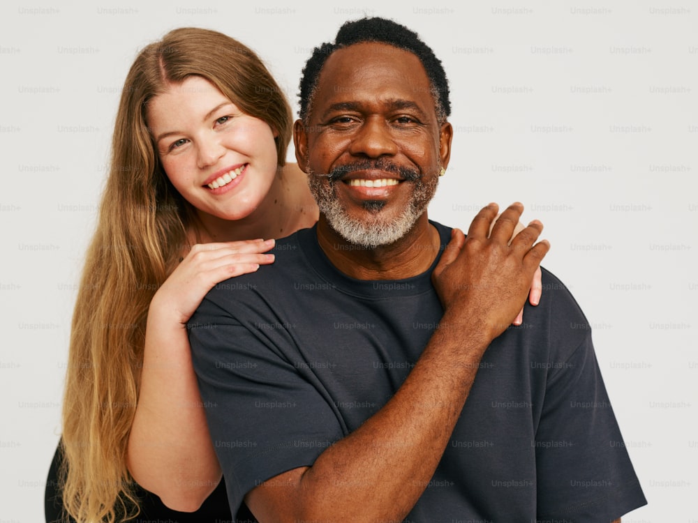 a woman hugging a man with a smile on his face