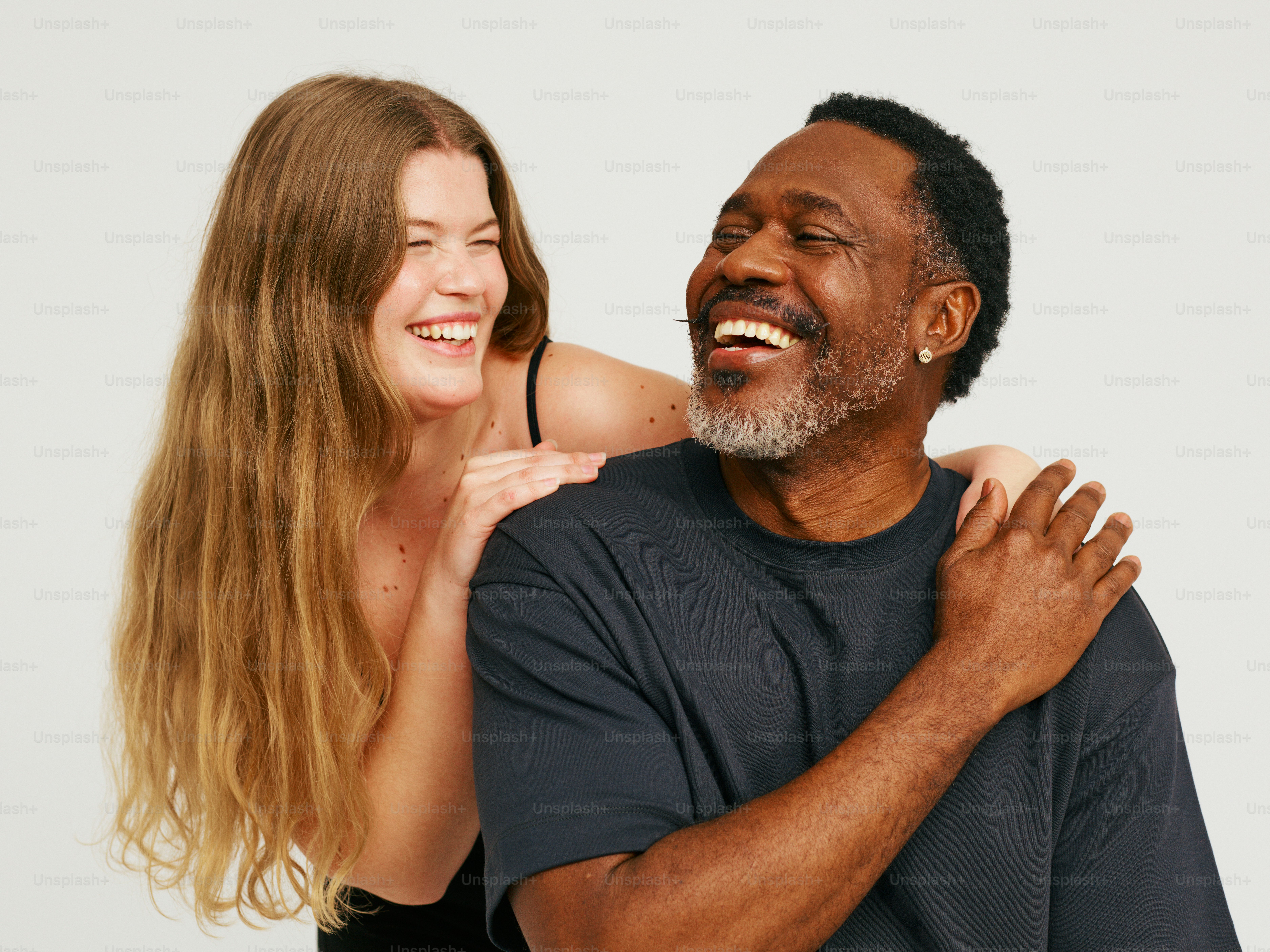 a man and a woman are laughing together