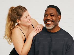 a woman hugging a man with a smile on his face