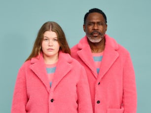 a man and a woman in pink coats