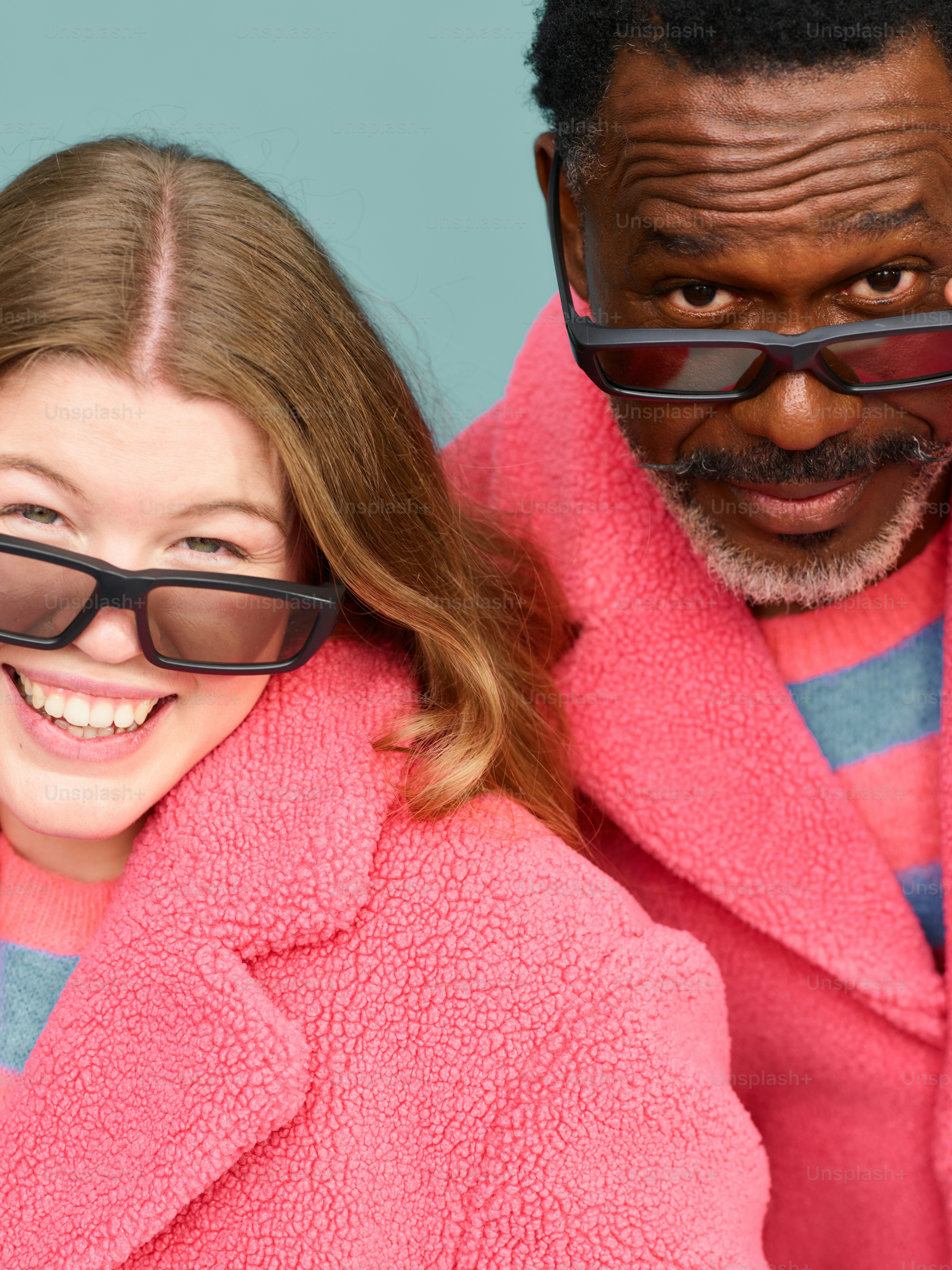 A man and a woman wearing sunglasses and a pink coat photo – Pink Image ...