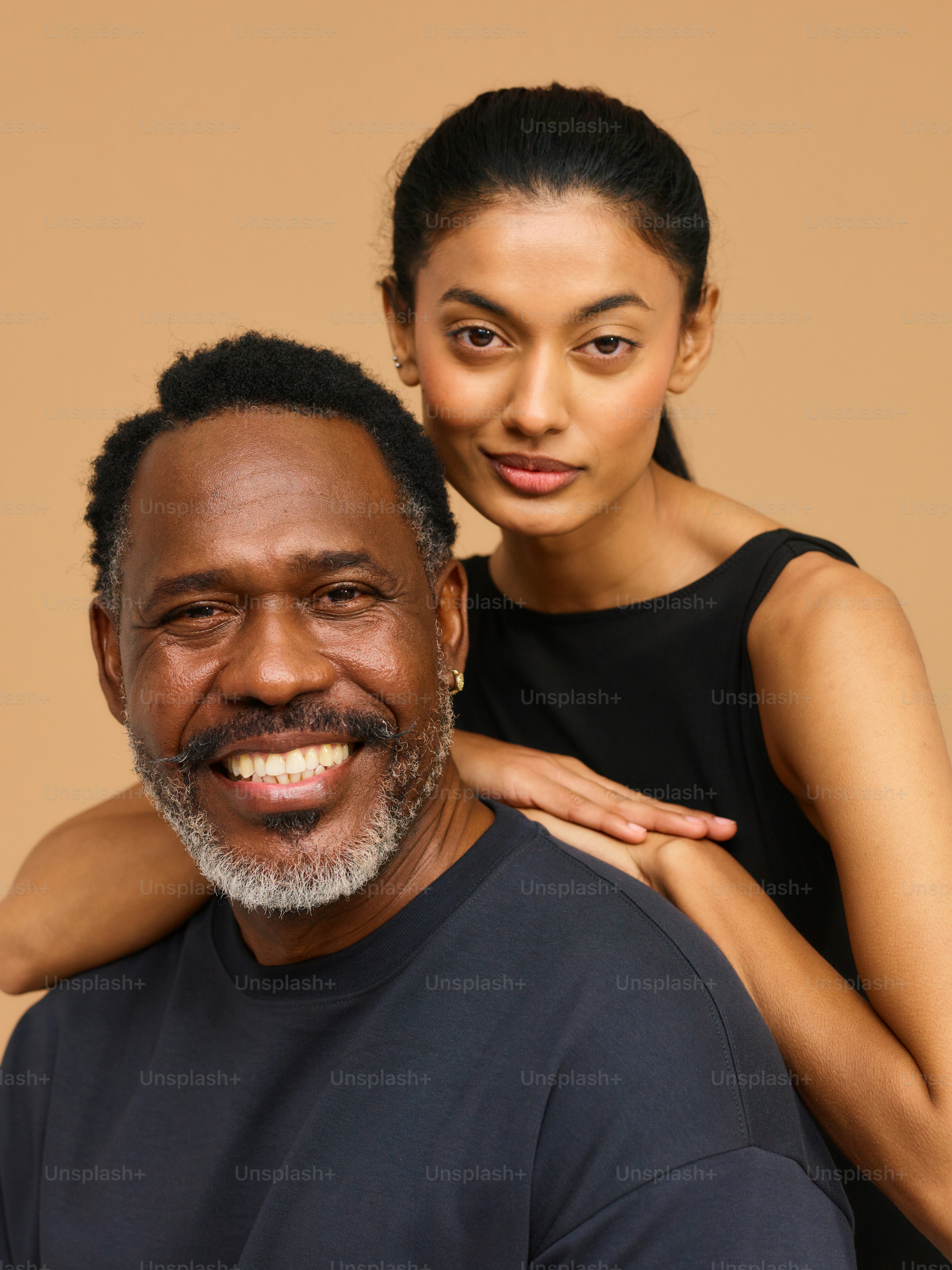 a woman standing next to a smiling man