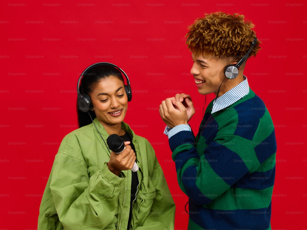 a man standing next to a woman wearing headphones