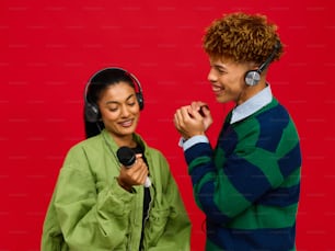 a man standing next to a woman wearing headphones