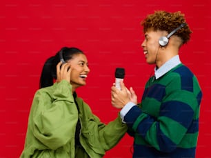 a man holding a microphone talking to a woman