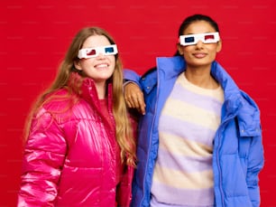 two women wearing 3d glasses standing next to each other