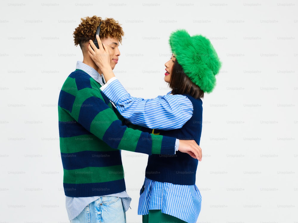 a man in a green hat and a woman in a blue sweater