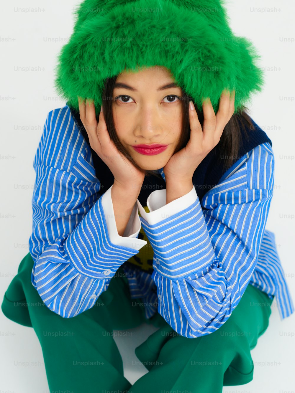 a woman with a green hat on her head