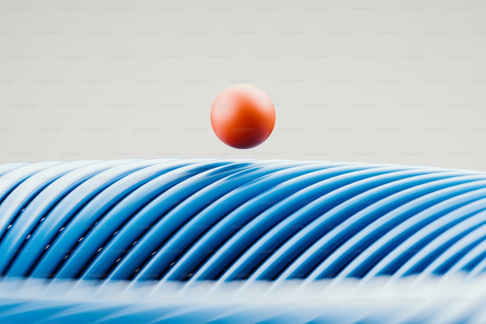 a red ball is flying over a blue object