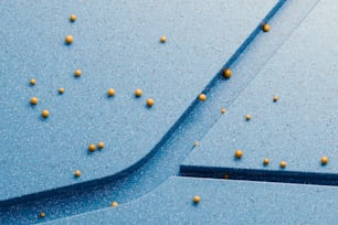 a blue surface with yellow balls on it
