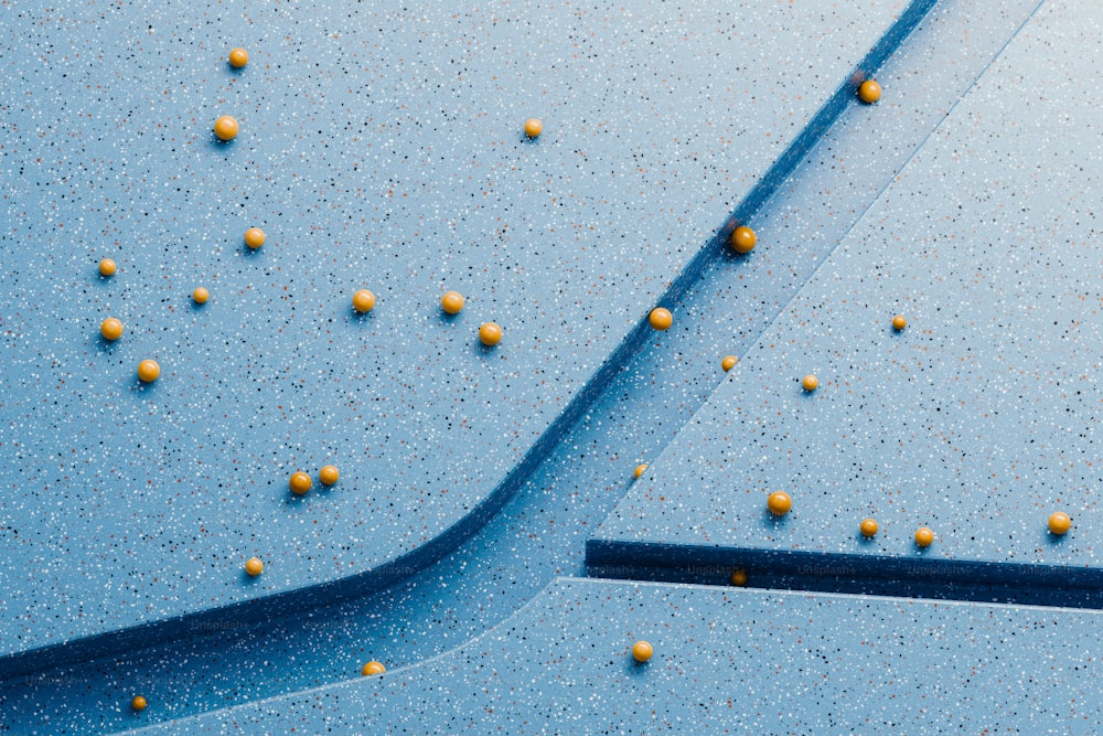 a blue surface with yellow balls on it