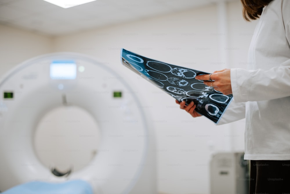 a person holding a piece of paper in front of a toilet