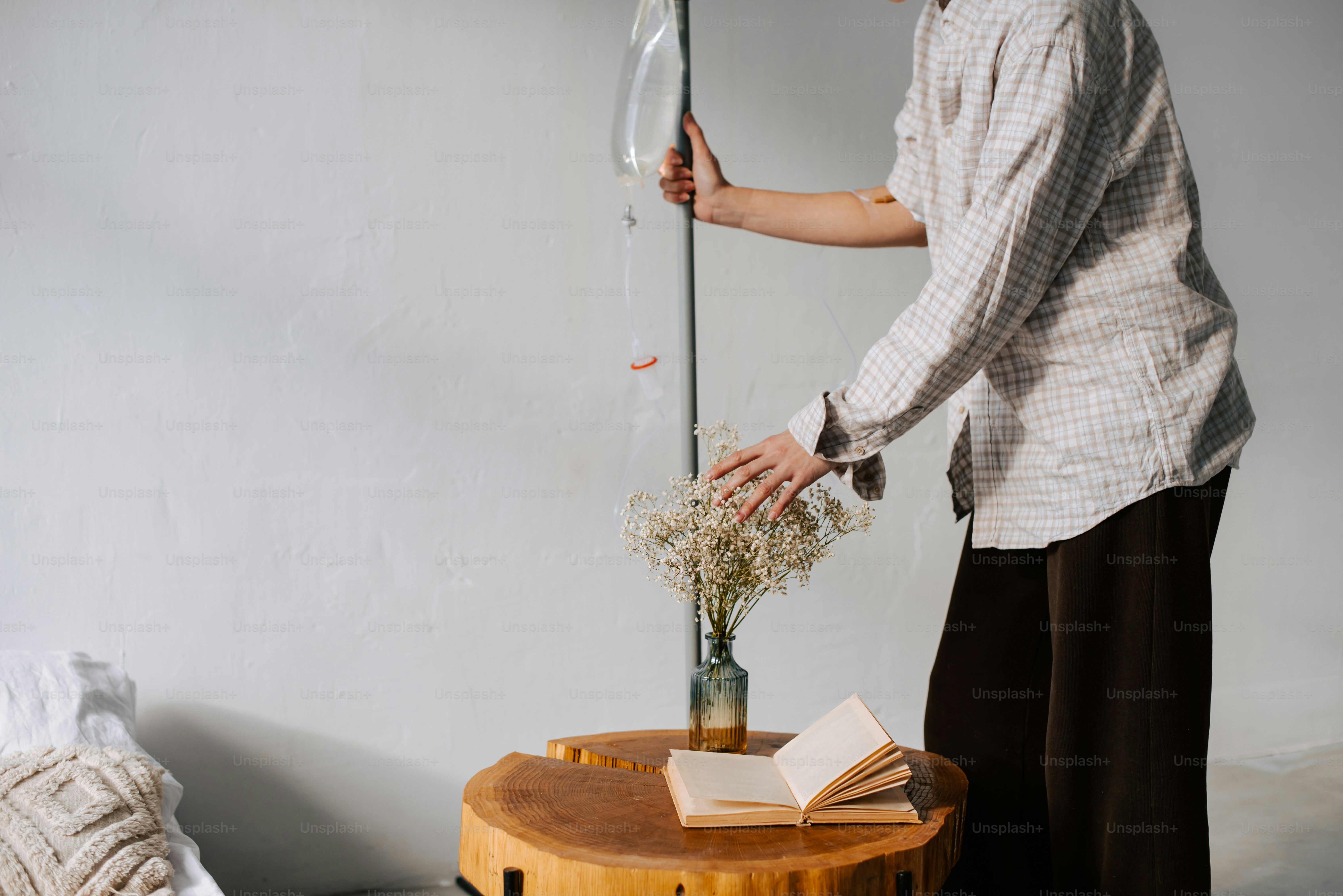 a person standing next to a table with a book