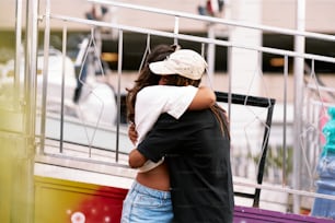 a man and a woman embracing on a balcony