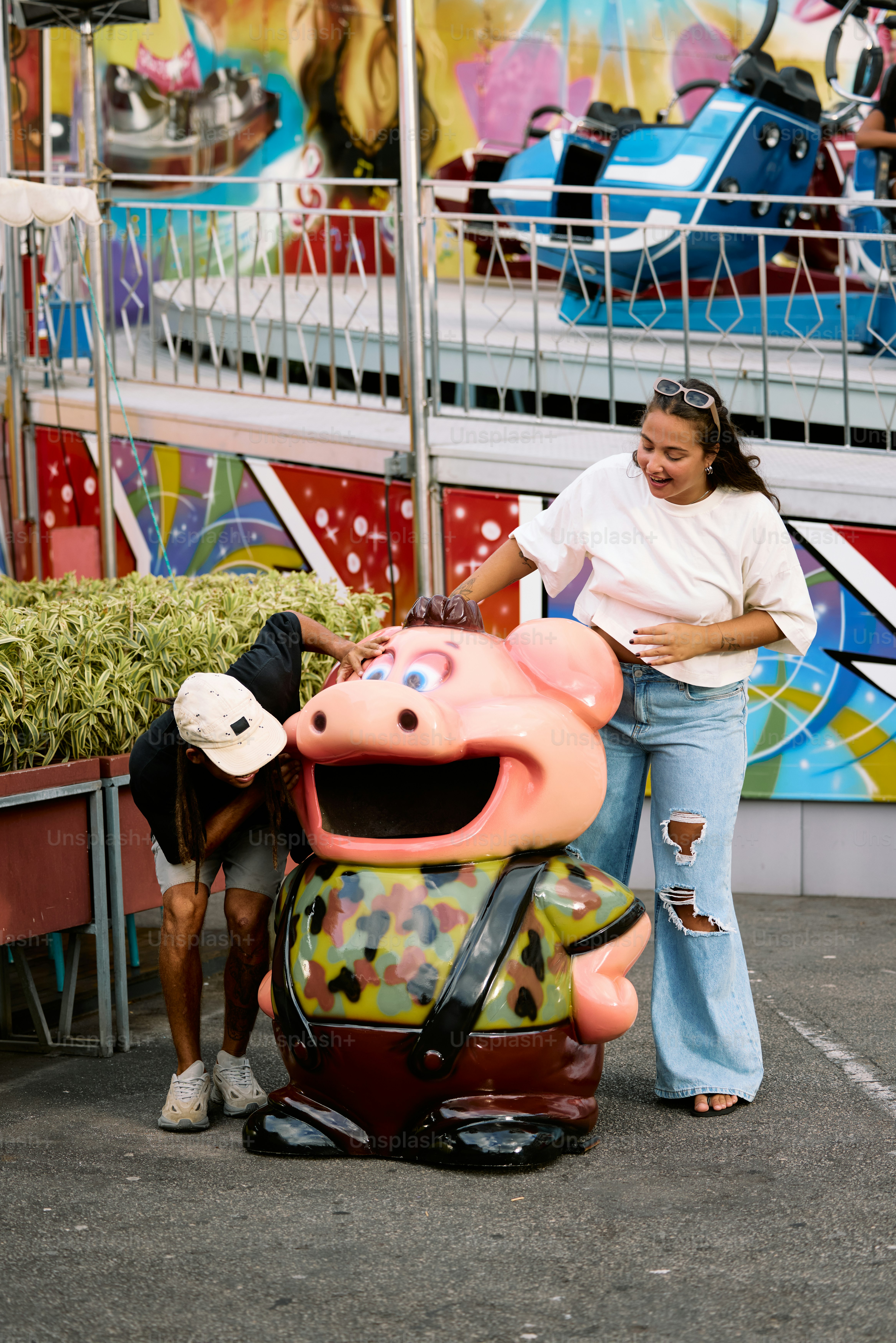a woman standing next to a statue of a pig