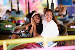 a man and a woman riding a roller coaster at a carnival