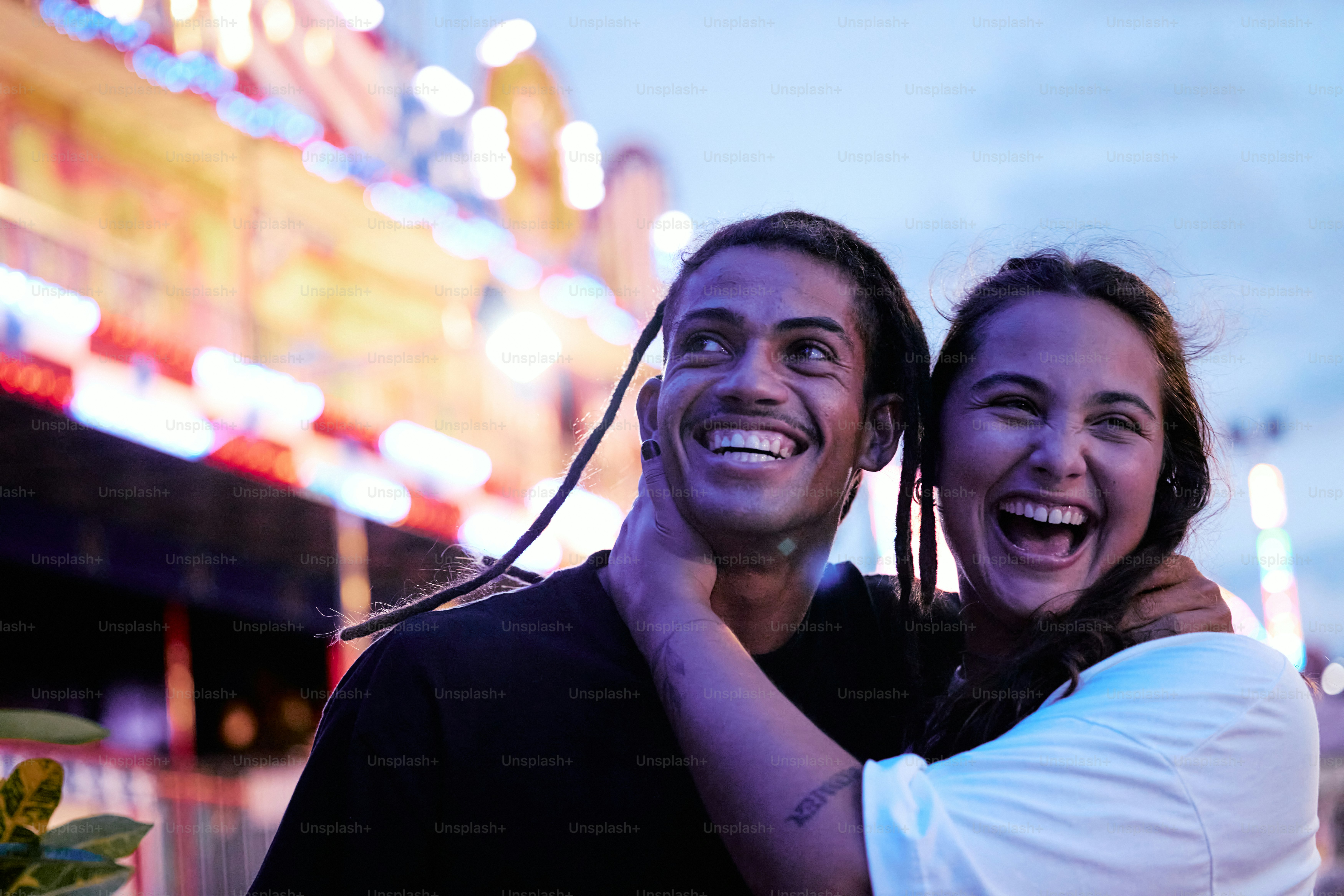a man and a woman are smiling at the camera