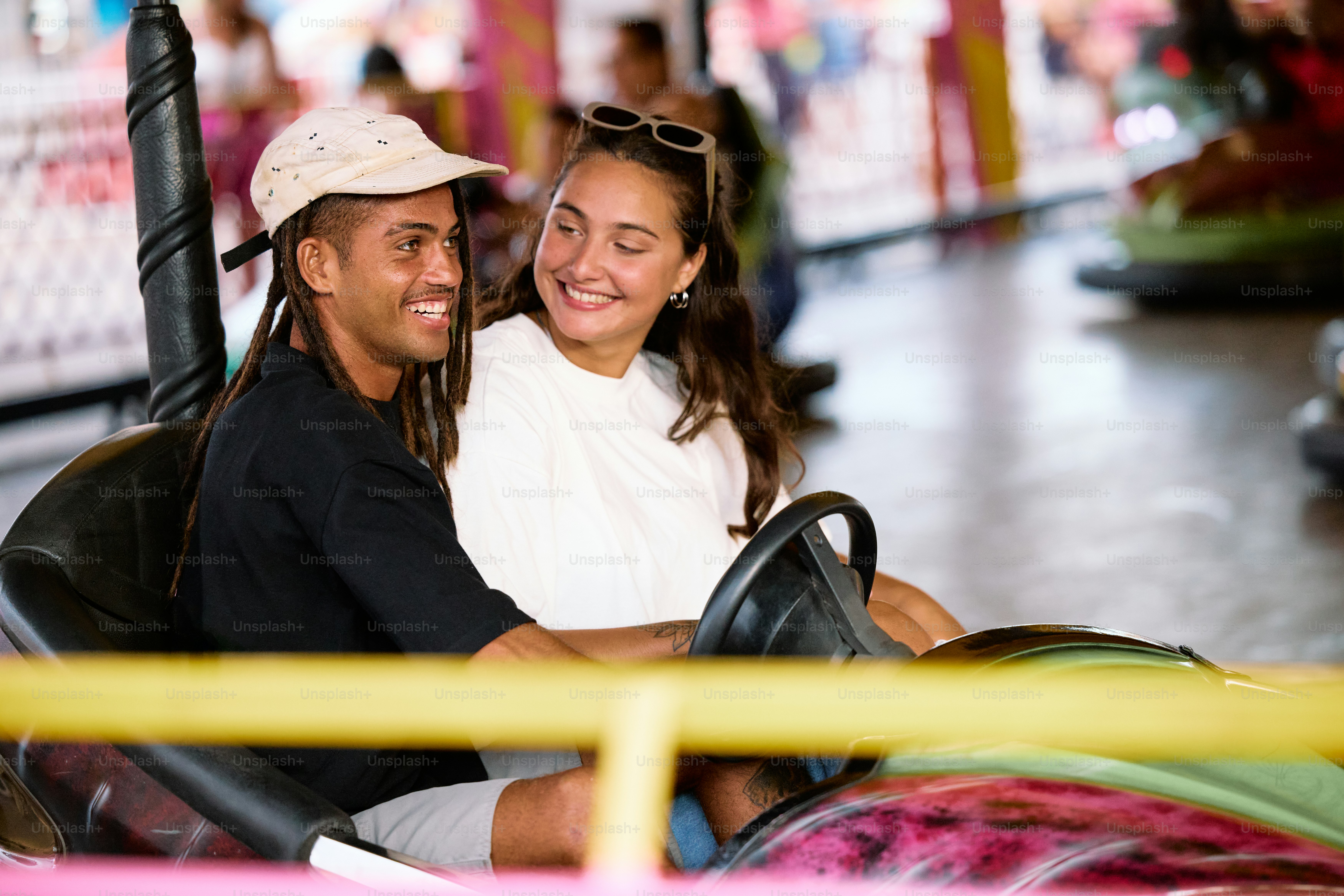 a man and a woman are riding a roller coaster