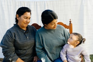 a woman and a child sitting on a bench