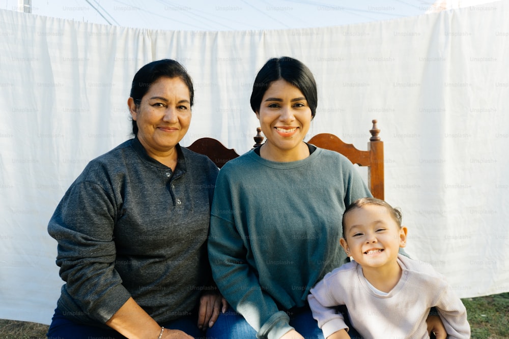 a woman and a child sitting on a chair