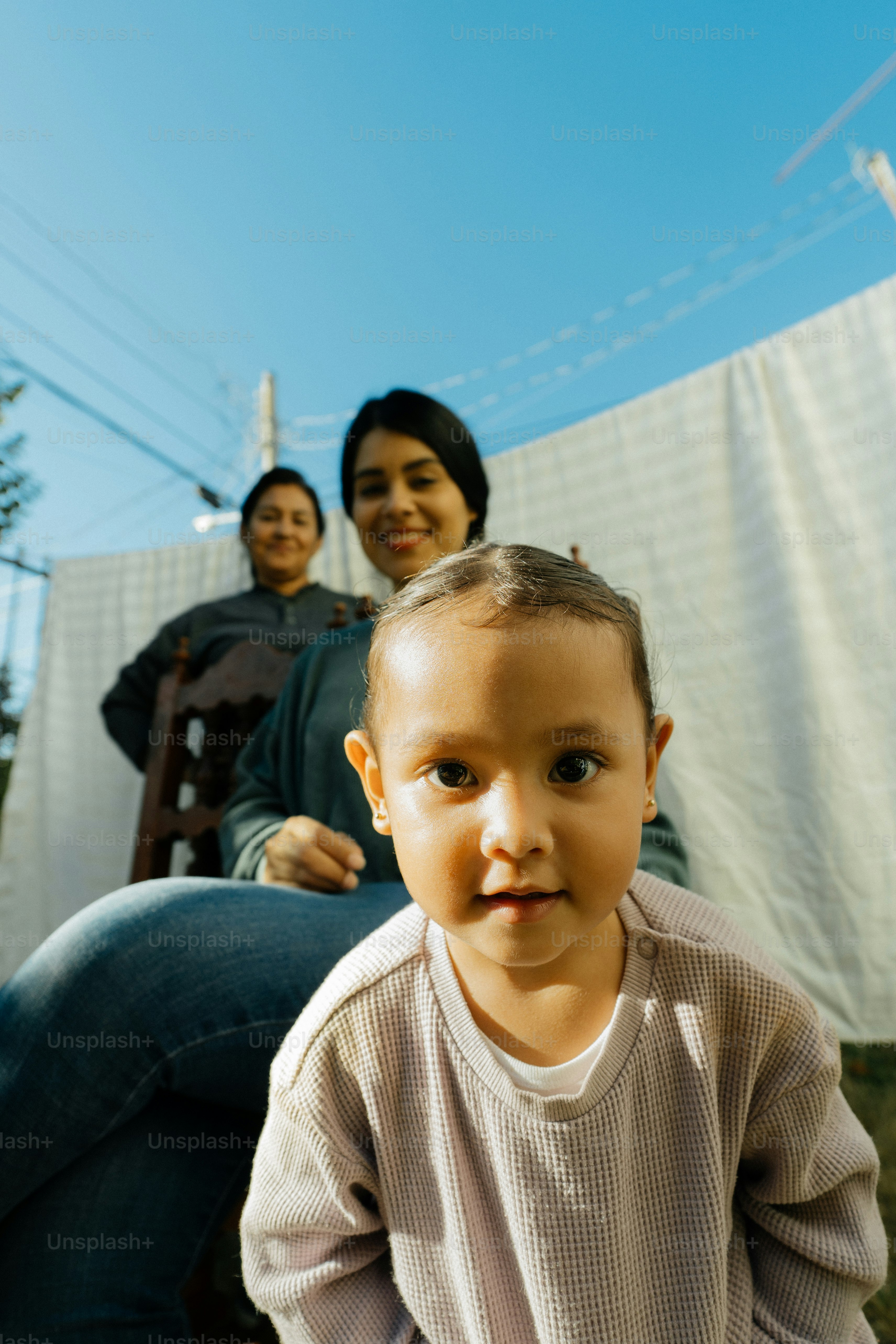 a woman sitting next to a little boy