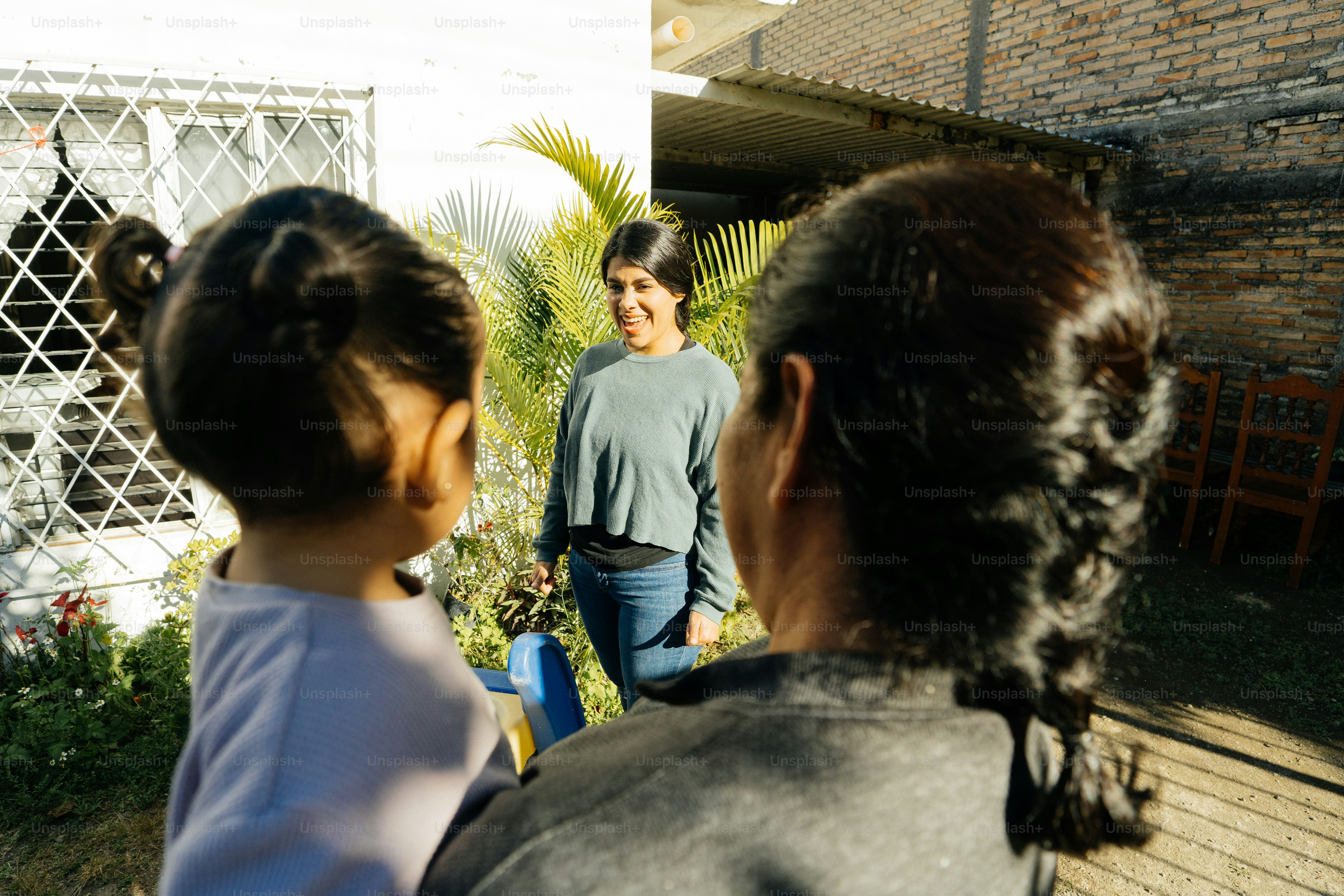 a woman standing next to a little girl