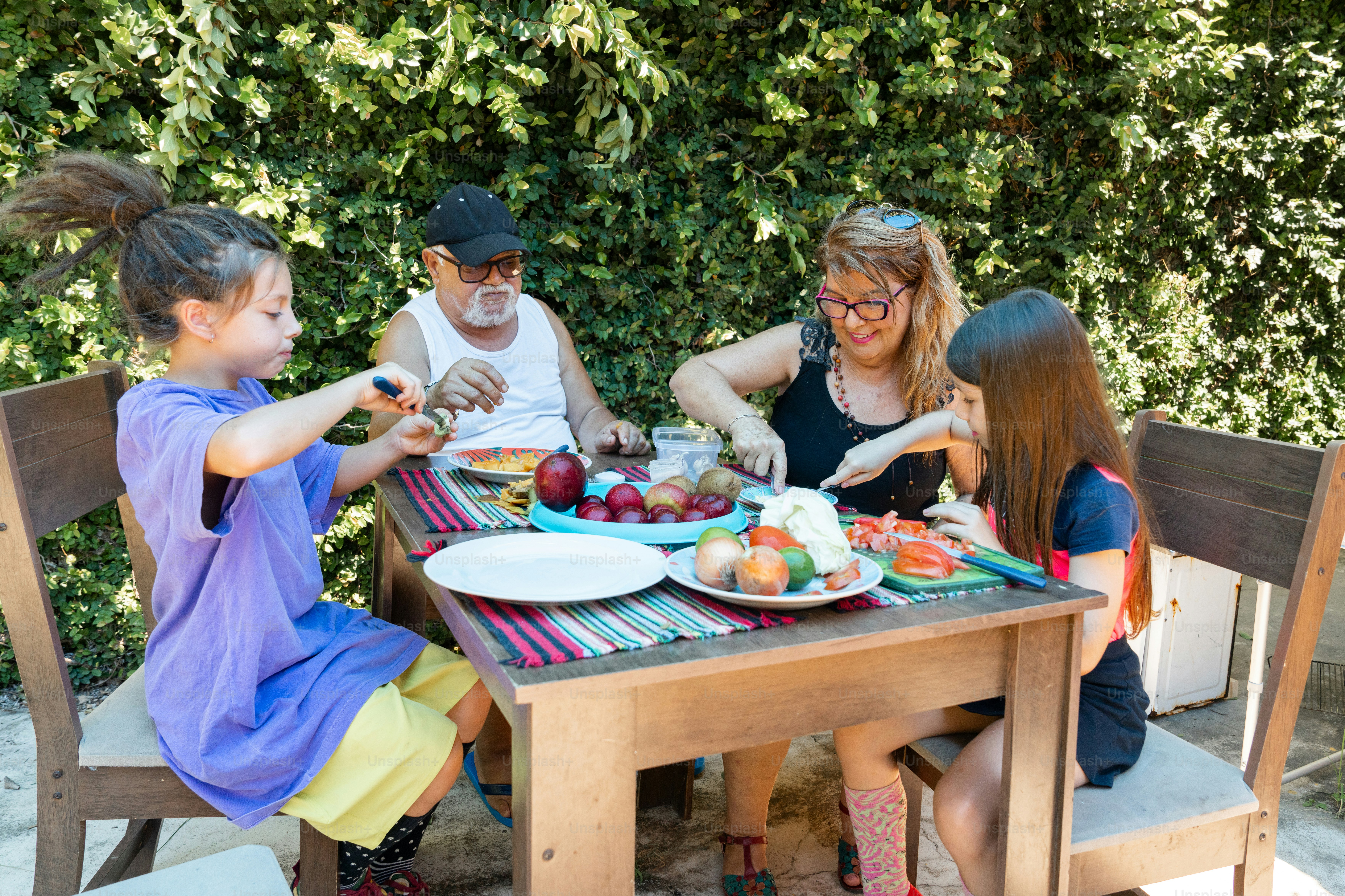 a group of people sitting around a table eating food